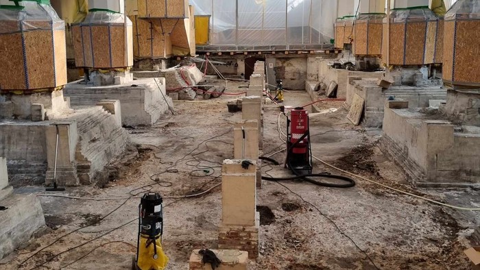 En byggeplads med betonpiller og materialer.