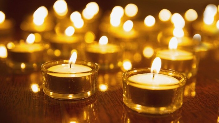 Several lit candles in glass holders create a warm, inviting atmosphere.