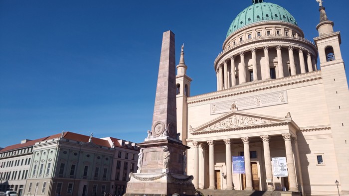 Großer Platz mit Obelisk, Kirche und Menschen