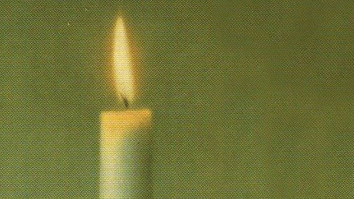 Plakat med tændt stearinlys og dansk tekst