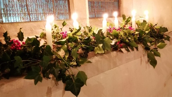 Candles and flowers on window sill