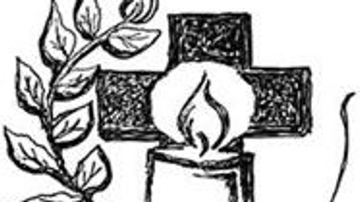 Ein Kreuz mit einer brennenden Kerze und einem Zweig.