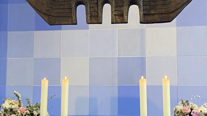 Altar in Kirche mit Kerzen und Blumen