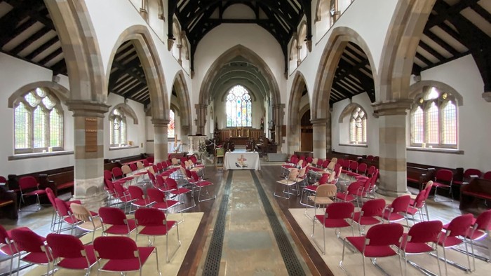 Church interior with red chairs and arched windows