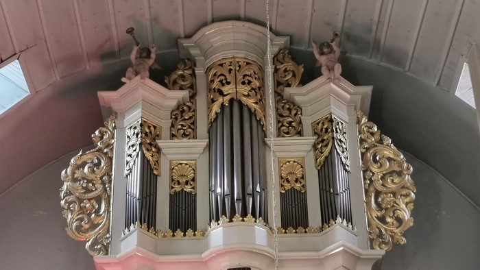 Prächtige Kirchenorgel mit aufwendigen Verzierungen und Figuren.