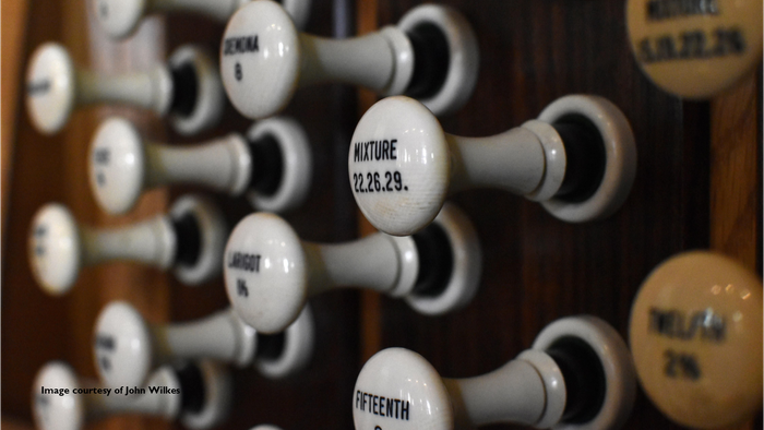 Close-up of organ knobs with labels such as Mixture and Fifteenth.