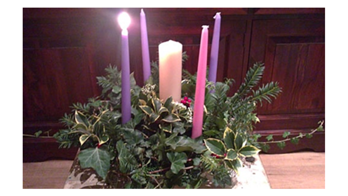 Candles on plant decoration in wooden room