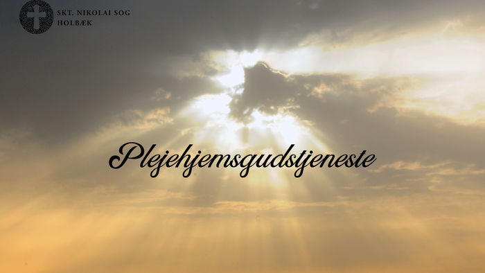 Solnedgang med lysstråler og tekst på dansk