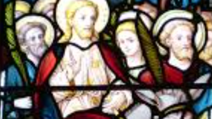 Farvet glas viser Jesus på et æsel, omgivet af følgere.