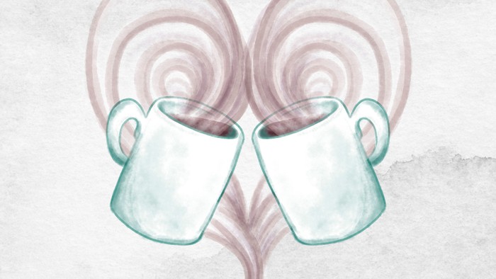 To mugs i form af et hjerte med damp.