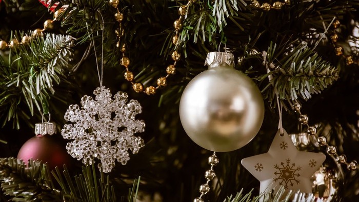 En juletree med pynt med glitrende kugler og snestjerner