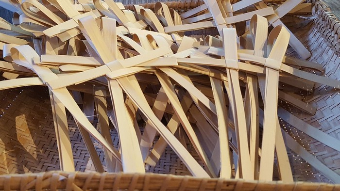 Bamboo strips in a woven basket.