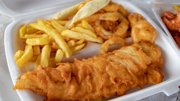 Fried fish and chips in a takeout container