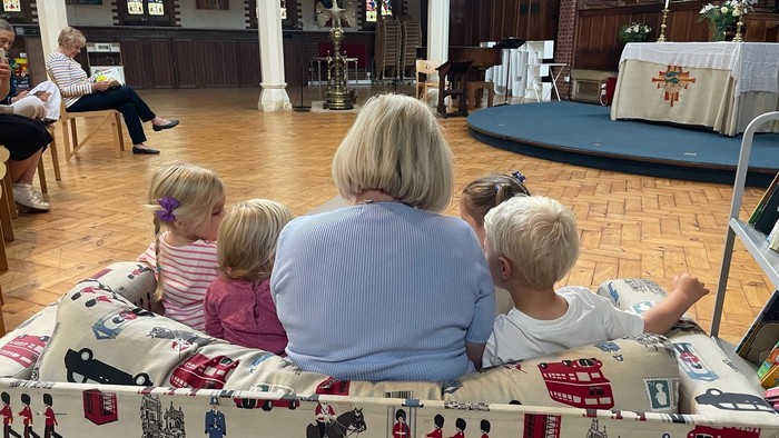 Family with children sitting in church pew