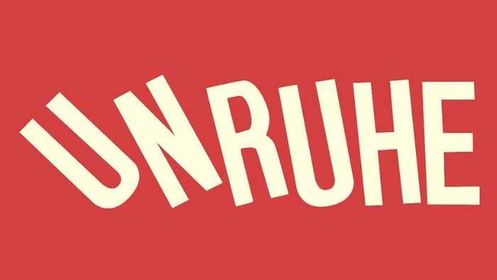 Logo des Kollektivs Unruhe e.V. mit weißer Schrift auf rotem Hintergrund