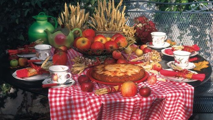 Ein festlich gedeckter Tisch mit Obst, Kuchen und Tee.