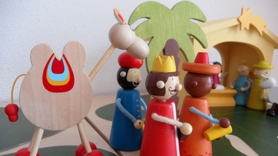 Trælegetøj arrangeret i en legesjov scene med en palme og et lille hus.