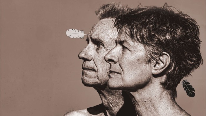 Ein älteres Paar, das sich anschaut, mit Federn im Haar