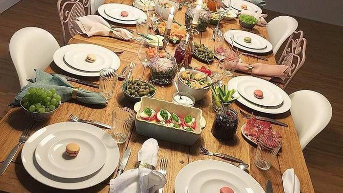 Ein festlich gedeckter Tisch mit weißem Geschirr, Besteck, Blumen und verschiedenen Gerichten.