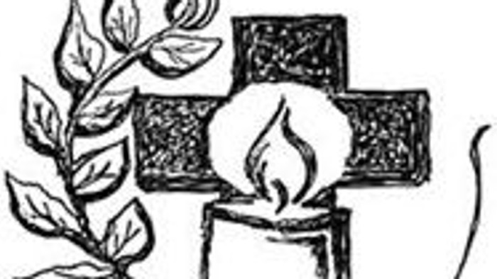 Ein Kreuz mit einer brennenden Kerze und einem Zweig.