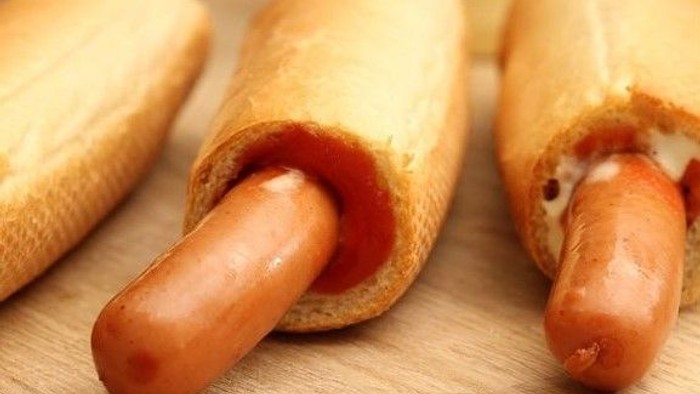 To franske hotdogs med ketchup og hotdog-dressing