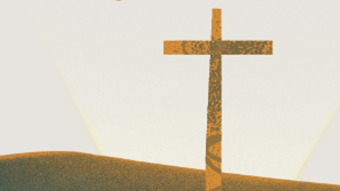 En stor korsformet struktur står på en bakke med sollys i baggrunden