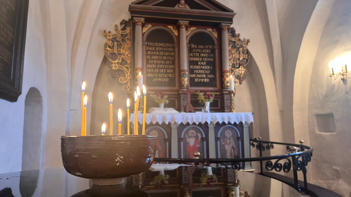 Kirkealter med stearinlys og religiøse ikoner.