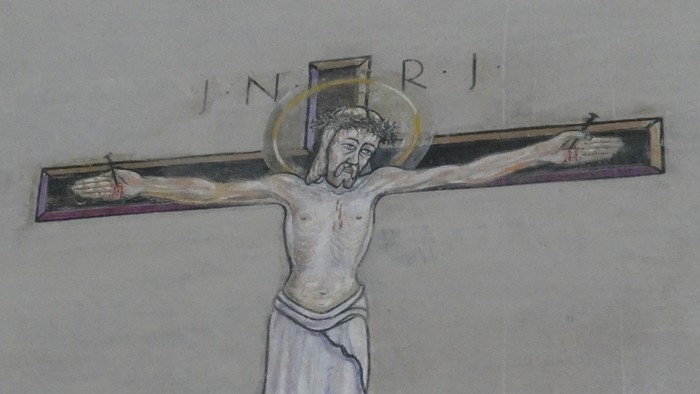 Das Bild zeigt ein Kruzifix an einer Wand.