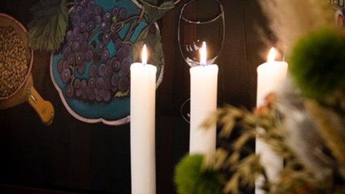 Bord med lyse lysstaker og blomsterarrangement