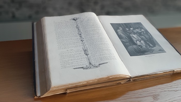 Offenes Buch mit Kreuz im Hintergrund