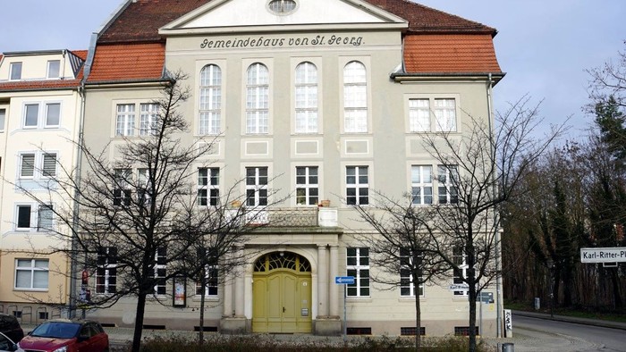 Gemeindehaus St. Georg am Karl-Ritter-Platz. Dreigeschossiger Bau mit grauer Fassade.