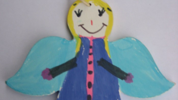 Ein selbstgemachtes Engel-Dekoration mit blauen Flügeln und rosa Kleid.