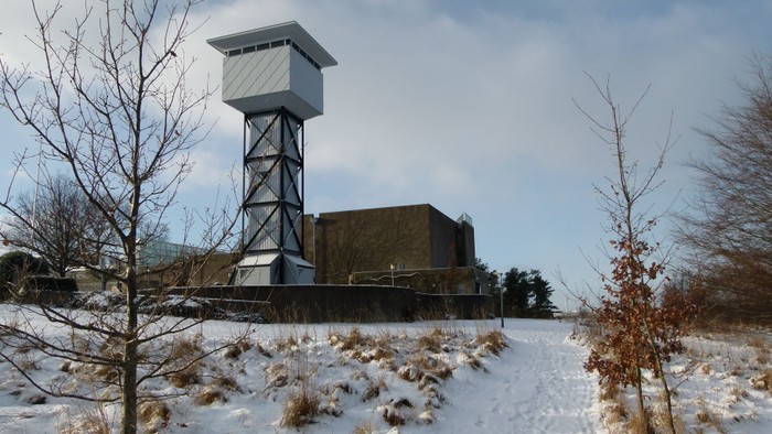 En høj vandtårn i snelandsby.