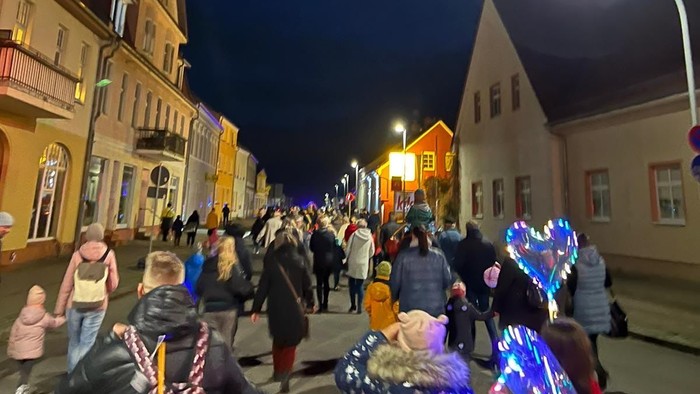 Menschen feiern bei Nacht auf einer belebten Straße
