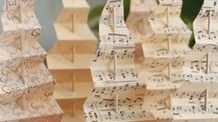 Små juletræ af noter med stjerner på toppen.