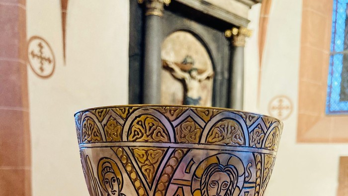 Ein verzierter Kelch steht auf einem Tisch in einer Kirche