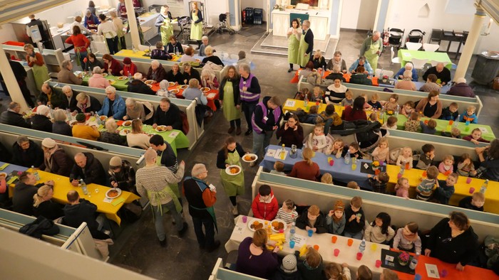 Meschen essen gemeinsam in der St.-Georgs-Kirche