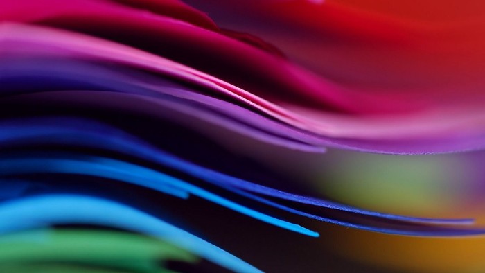 Auf dem Bild sind unterschiedliche Farben in Wellenbewegung zu sehen.