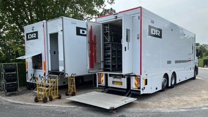 To vogne med DR-logo er åbne og parkeret i en parkingplads.