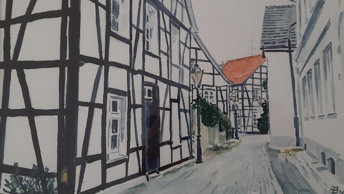 Aquarellmalerei einer malerischen, schneebedeckten Straße, gesäumt von traditionellen Fachwerkhäusern.