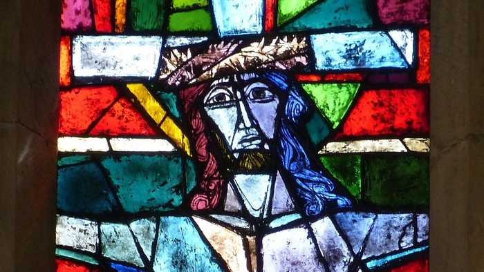 Farvet glasafbildning af Jesus Kristus kronet med tornekrone, draperet i et grønt klæde.