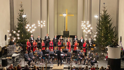 Kirkekor optræder med julekoncert med pyntede træer og publikum.