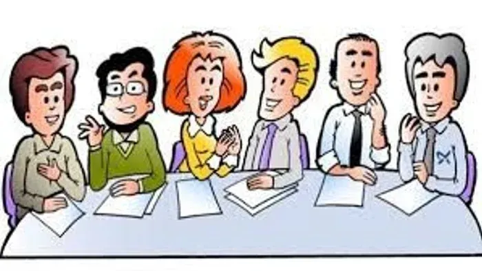 En gruppe af seks personer sidder ved et bord og diskuterer.