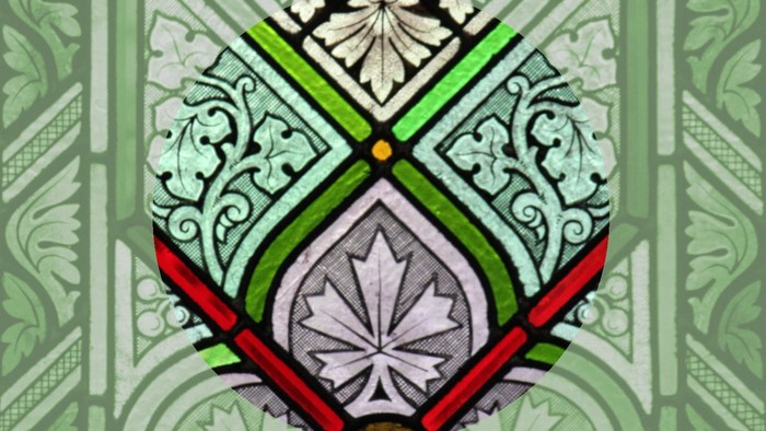 Das Bild zeigt ein filigranes Wappen mit grünen und roten Akzenten auf weißem Hintergrund.