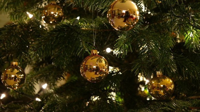 En juletree med guldfarvede pynt.