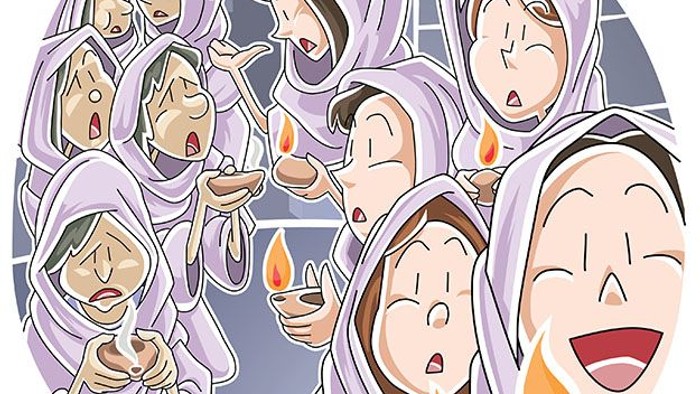 Group of people holding lit candles, smiling and looking upwards.