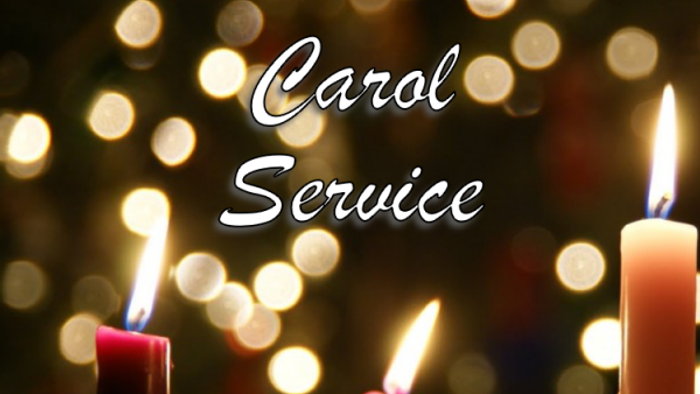 Candles lit for Carol Service, blurred lights in background