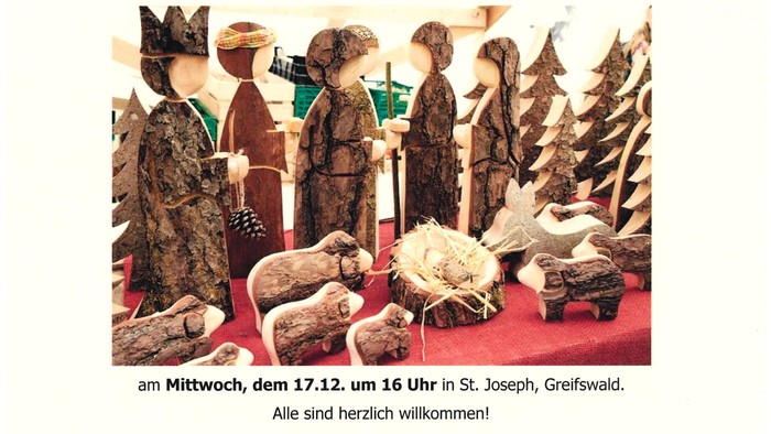 Krippenszene mit Holzfiguren und deutschem Text