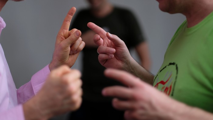 Drei Personen reichen sich die Hände