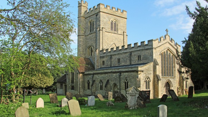Church with graveyard and trees.